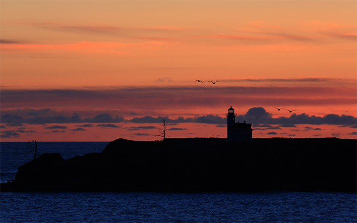 arago lighthouse sunset photo dark